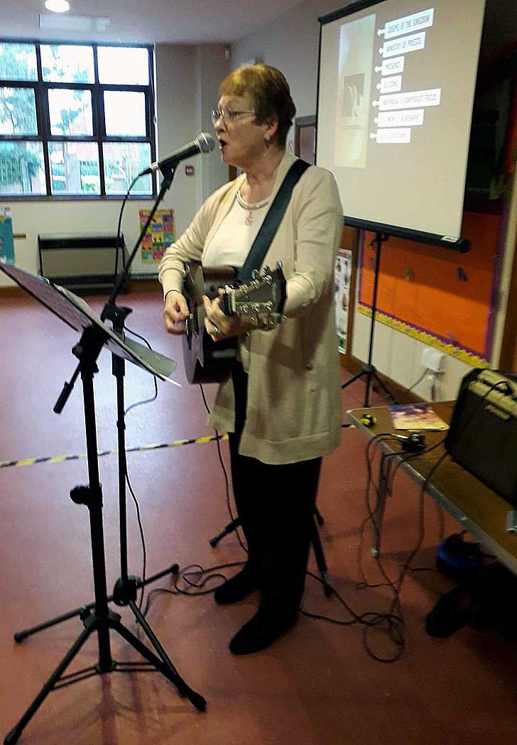 Linda playing guitar